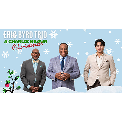 A light blue graphic featuring snowflakes falling behind three men in suit jackets next to a cartoon depiction of the sad, bare Christmas tree from the Peanuts Christmas special. Words in the corner of the graphic read ERIC BYRD TRIO - A CHARLIE BROWN CHRISTMAS.